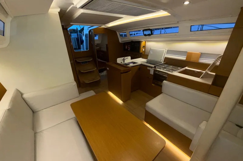 Slide: The Image of Interior of 2022 Jeanneau Sun Odyssey 410 yacht with modern kitchen and seating area. - 39