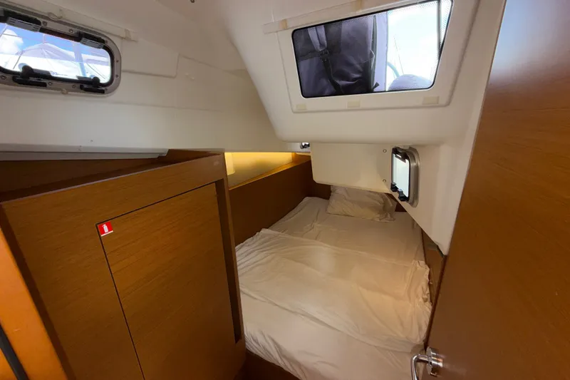 Slide: The Image of Cozy cabin interior of 2022 Jeanneau Sun Odyssey 410 sailboat with wooden accents. - 29