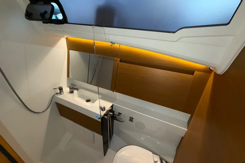 Slide: The Image of Modern bathroom interior of 2022 Jeanneau Sun Odyssey 410 yacht, featuring sleek design and lighting. - 33