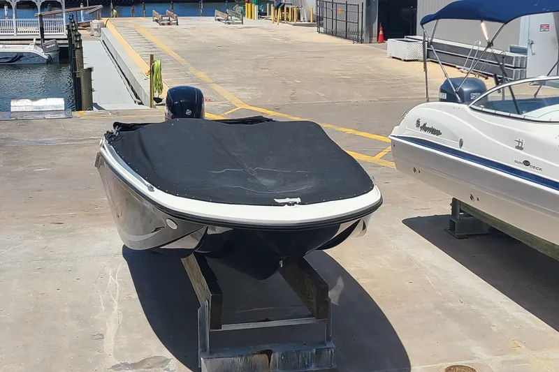 Slide: The Image of 2022 Bayliner Element M17 boat covered and docked at a marina. - 18