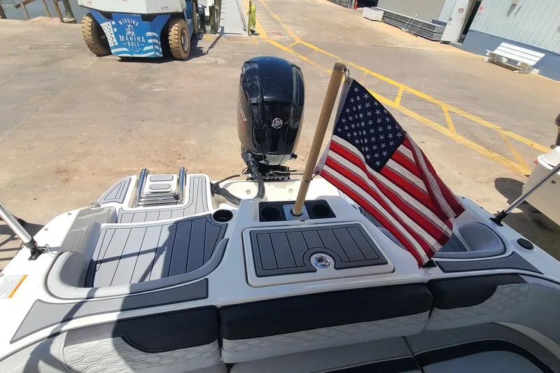 Slide: The Image of 2022 Bayliner Element M17 boat with American flag at marina dock. - 13
