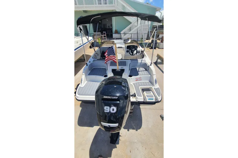 Slide: The Image of 2022 Bayliner Element M17 boat with Mercury 90 engine and American flag. - 14