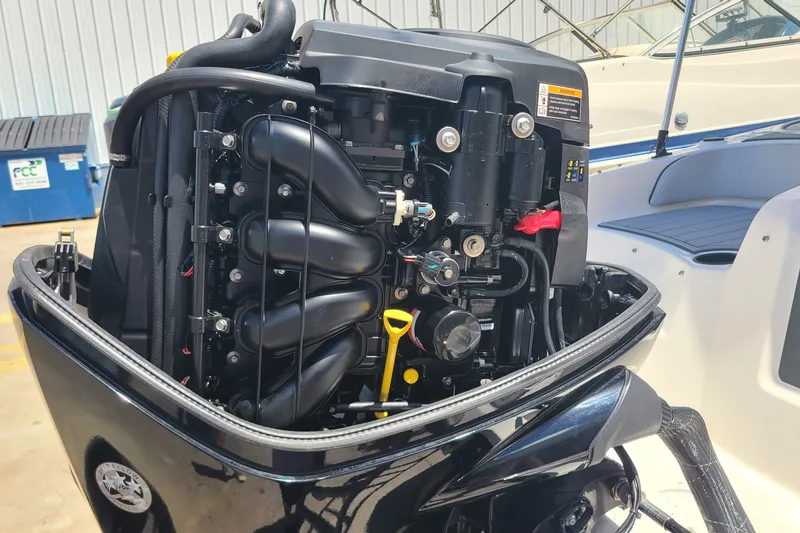 Slide: The Image of 2022 Bayliner Element M17 outboard engine, detailed view in a boatyard setting. - 15