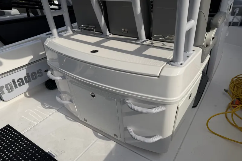 Slide: The Image of 2021 Everglades 335 Center Console boat interior with storage compartments and seating. - 12