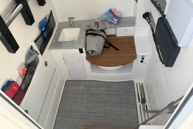 Slide: The Image of Interior of 2021 Everglades 335 Center Console boat with sink and storage. - 24