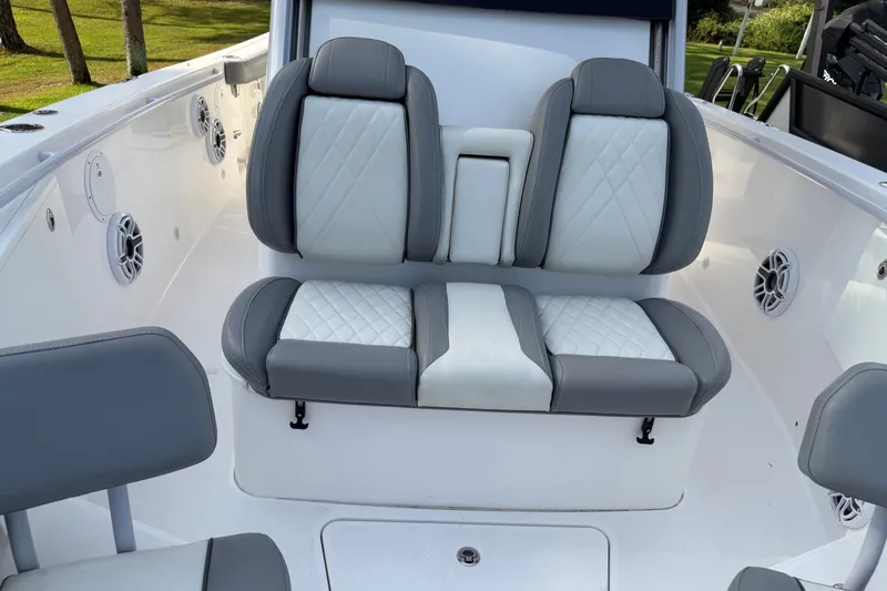 Slide: The Image of 2021 Everglades 335 Center Console boat interior with cushioned seating and speakers. - 19