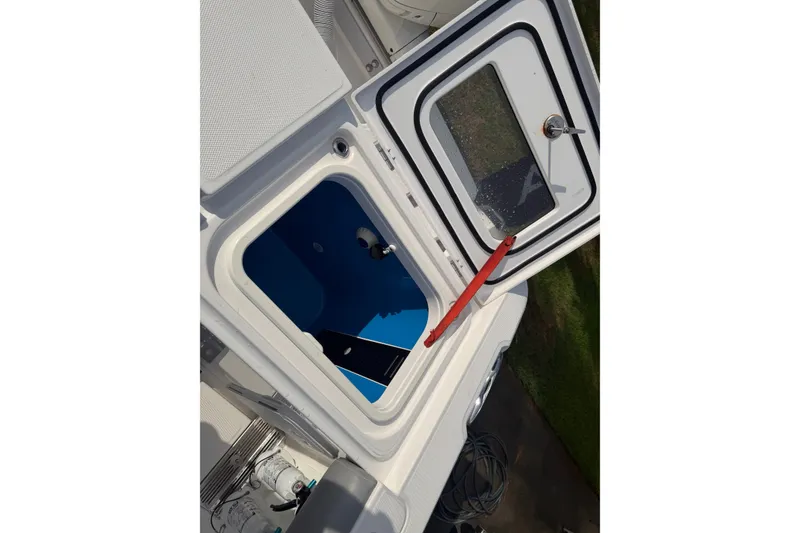 Slide: The Image of Open hatch on 2021 Everglades 335 Center Console boat, showing interior compartment. - 11