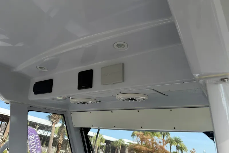 Slide: The Image of Interior view of 2021 Everglades 335 Center Console boat's ceiling with speakers and controls. - 17