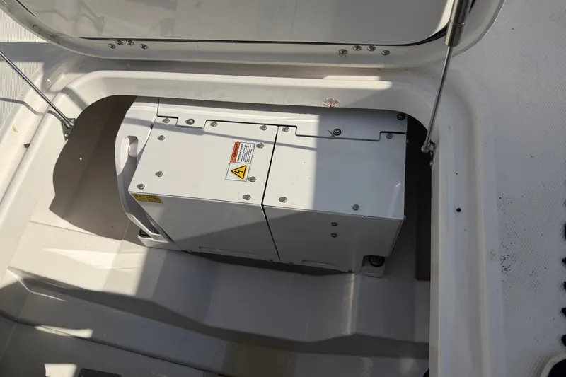 Slide: The Image of 2021 Everglades 335 Center Console boat storage compartment with equipment inside. - 26