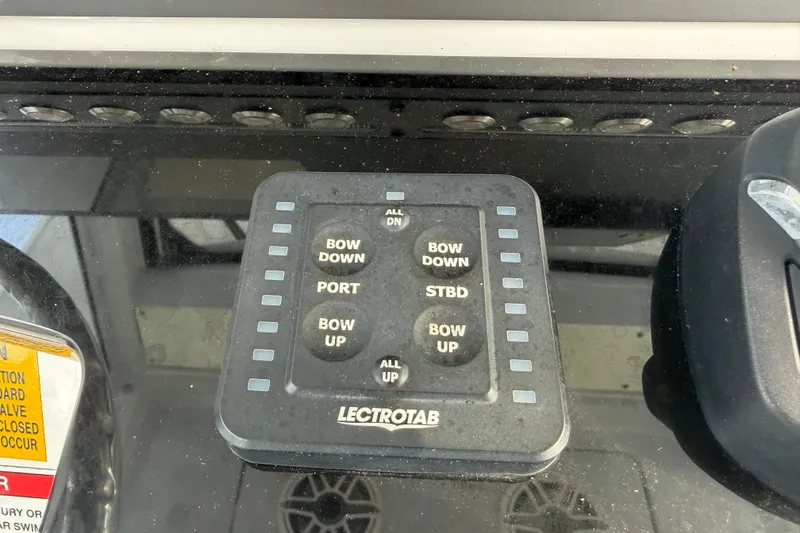Slide: The Image of Control panel of a 2021 Everglades 335 Center Console boat with Lectrotab trim tab switches. - 16