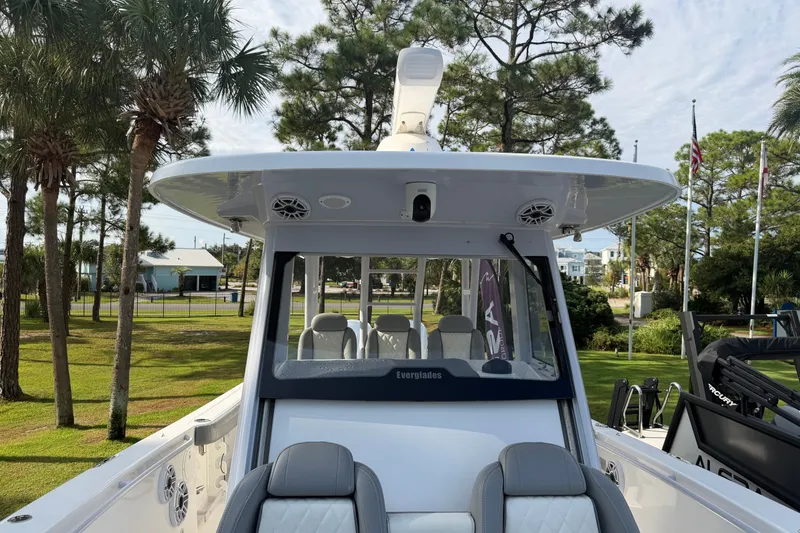 Slide: The Image of 2021 Everglades 335 Center Console boat with sleek design, docked near palm trees. - 21
