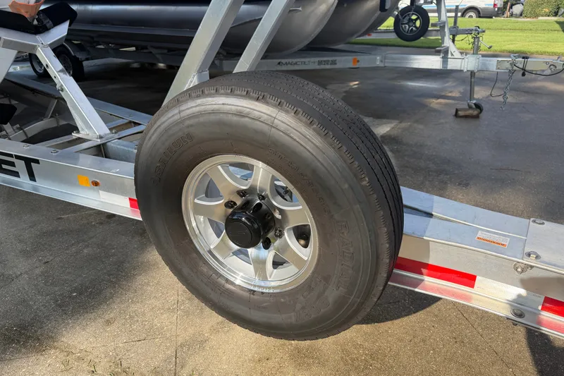 Slide: The Image of Trailer wheel of 2021 Everglades 335 Center Console boat on pavement. - 28