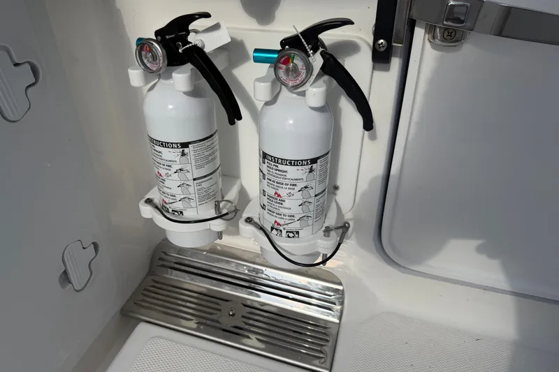 Slide: The Image of Two mounted fire extinguishers on a 2021 Everglades 335 Center Console boat. - 5