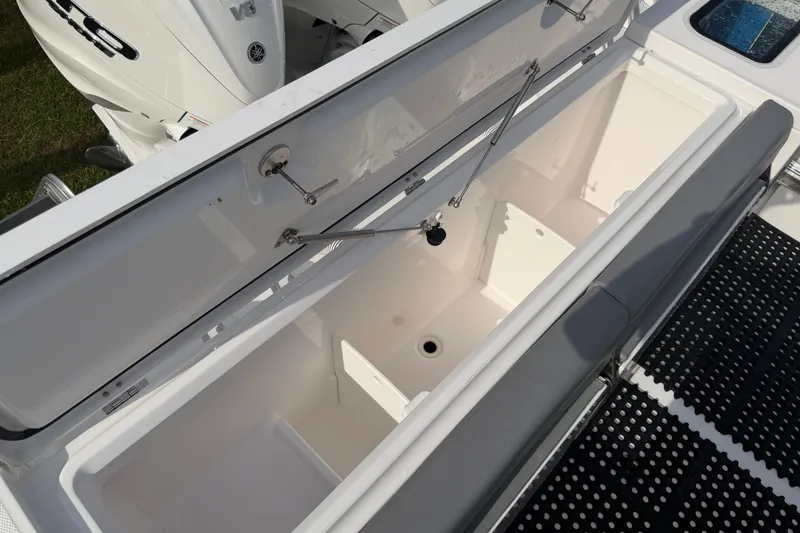 Slide: The Image of Open storage compartment on 2021 Everglades 335 Center Console boat. - 10