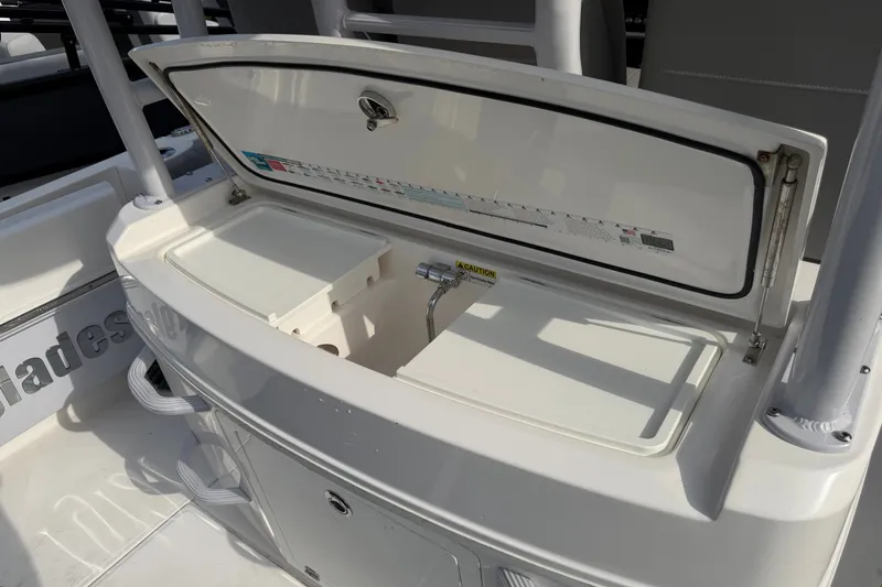 Slide: The Image of Open storage compartment on 2021 Everglades 335 Center Console boat. - 13