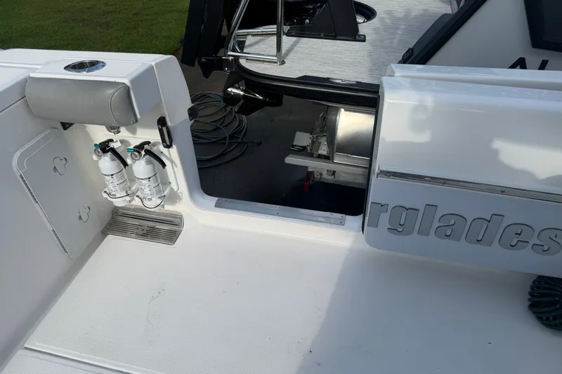 Slide: The Image of 2021 Everglades 335 Center Console boat deck with fire extinguishers and storage compartment. - 7