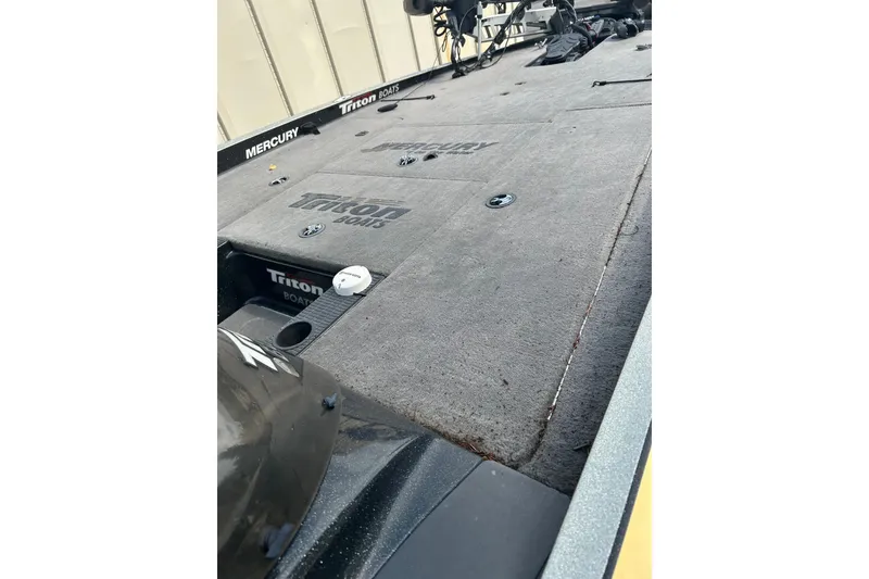 Slide: The Image of 2006 Triton 21 TrX boat deck with Mercury engine, featuring Triton Boats branding. - 5