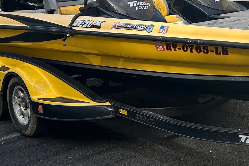 Slide: The Image of Yellow 2006 Triton 21 TrX boat on trailer, featuring registration number KY-0765-LK. - 9