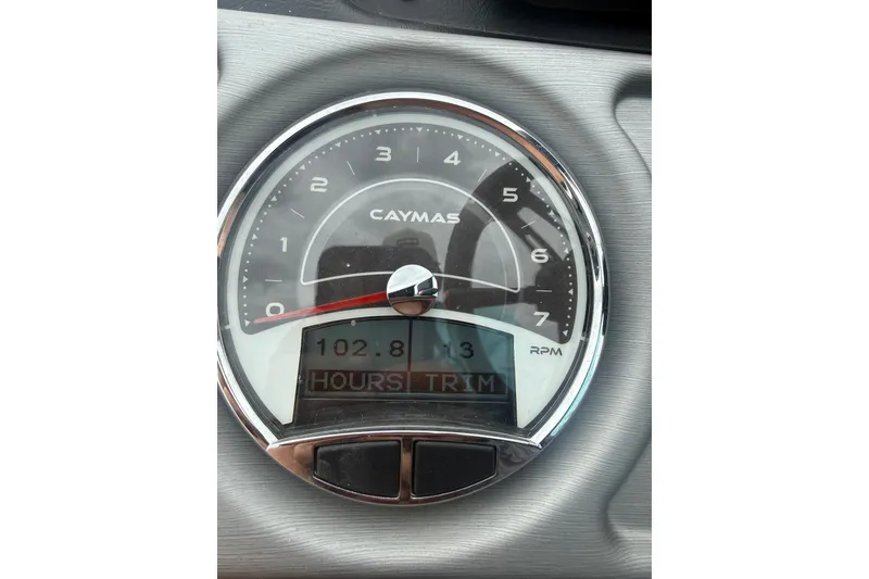Slide: The Image of Caymas CX 20 PRO 2020 tachometer displaying 102.8 hours and trim settings. - 9
