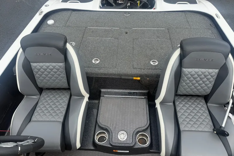 Slide: The Image of 2020 Caymas CX 20 PRO boat interior with gray quilted seats and storage compartments. - 12
