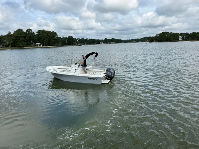 Slide: The Image of A 2023 Parker 1801 Center Console boat cruising on calm waters. - 15
