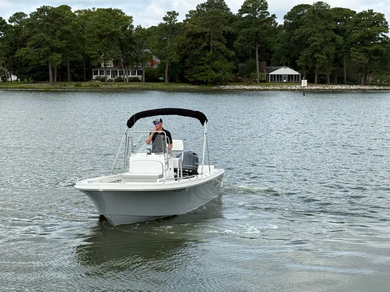 Slide: The Image of A 2023 Parker 1801 Center Console boat cruising on calm waters. - 16