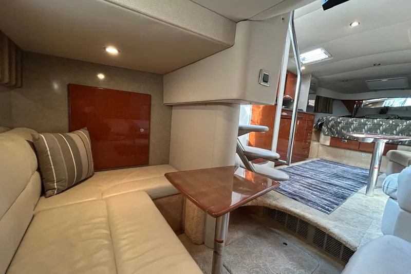 Slide: The Image of Interior of a 2005 Formula 34 Performance Cruiser, featuring cozy seating and elegant wood finishes. - 21