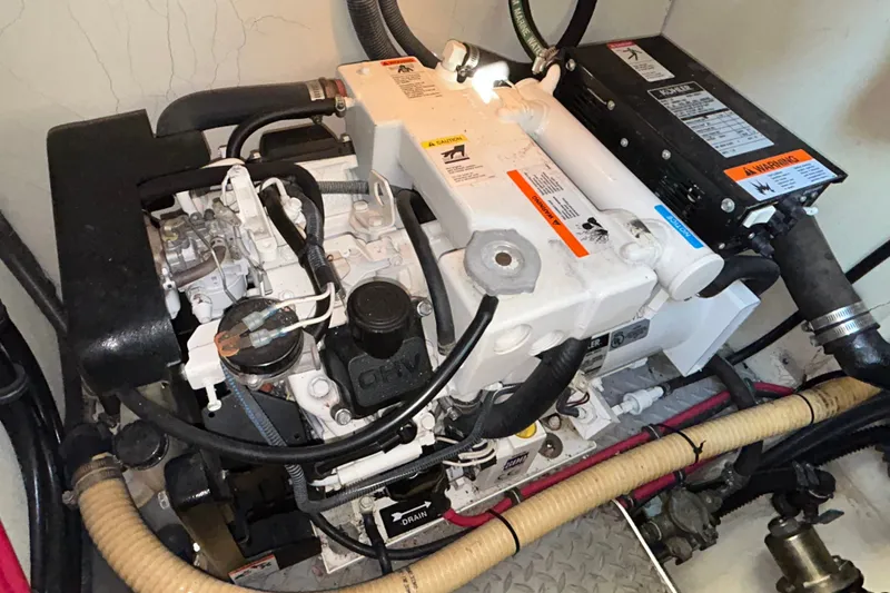 Slide: The Image of Engine compartment of a 2005 Formula 34 Performance Cruiser, showcasing mechanical components and wiring. - 28