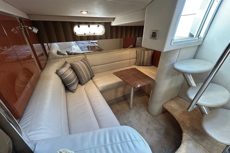 Slide: The Image of 2005 Formula 34 Performance Cruiser interior with plush seating and elegant wooden table. - 20