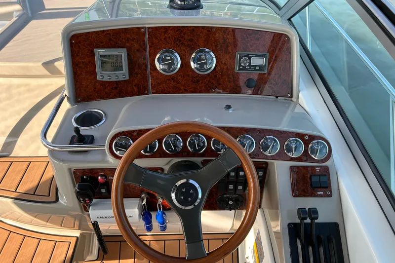 Slide: The Image of Dashboard of a 2005 Formula 34 Performance Cruiser with wood accents and steering wheel. - 9