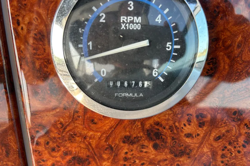 Slide: The Image of RPM gauge on 2005 Formula 34 Performance Cruiser dashboard with wood grain finish. - 13