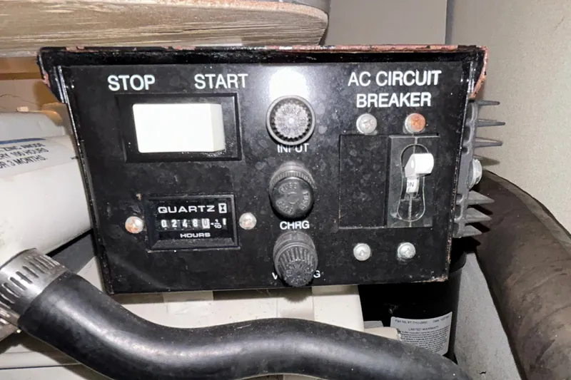 Slide: The Image of Control panel of a 2005 Formula 34 Performance Cruiser with AC circuit breaker and hour meter. - 29
