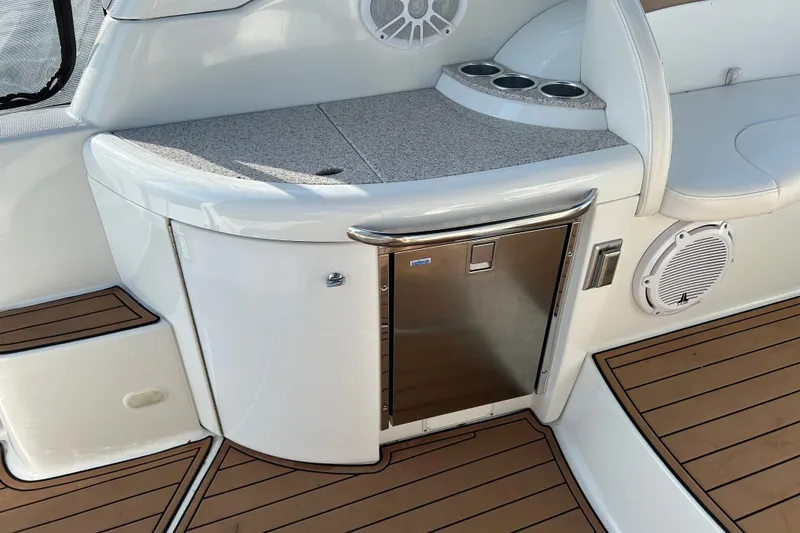 Slide: The Image of 2005 Formula 34 Performance Cruiser interior with fridge and cup holders on teak deck. - 6