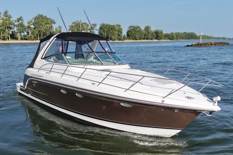 Slide: The Image of 2005 Formula 34 Performance Cruiser on a serene waterway, surrounded by lush greenery. - 1