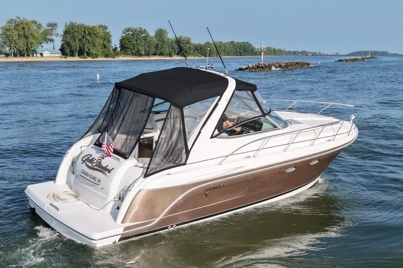 Slide: The Image of 2005 Formula 34 Performance Cruiser on open water, featuring sleek design and black canopy. - 2