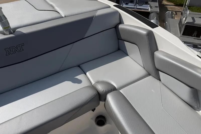 Slide: The Image of 2019 MasterCraft NXT20 boat interior with gray cushioned seating. - 13