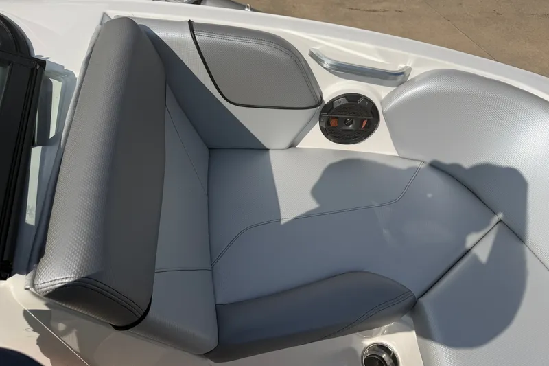 Slide: The Image of 2019 MasterCraft NXT20 boat interior with gray seating and speaker detail. - 18