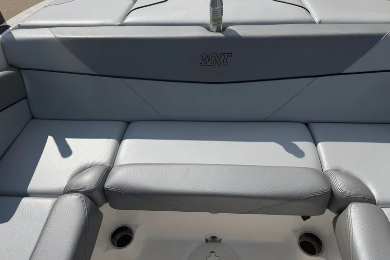 Slide: The Image of 2019 MasterCraft NXT20 boat interior with gray seating and NXT logo. - 12
