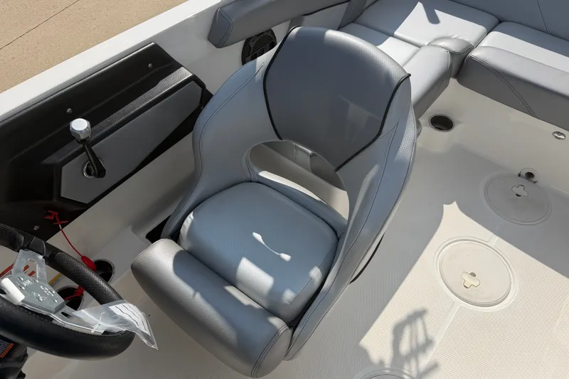 Slide: The Image of 2019 MasterCraft NXT20 boat interior with gray captain's seat and steering wheel. - 10