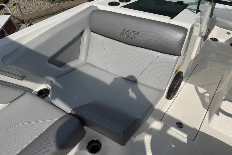 Slide: The Image of 2019 MasterCraft NXT20 boat interior with gray seating and cup holders. - 15