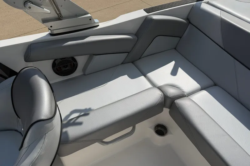 Slide: The Image of 2019 MasterCraft NXT20 boat interior with gray seating and speaker detail. - 11