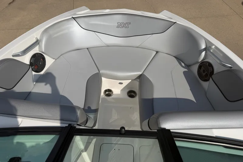Slide: The Image of 2019 MasterCraft NXT20 boat interior with gray seating and built-in speakers. - 17