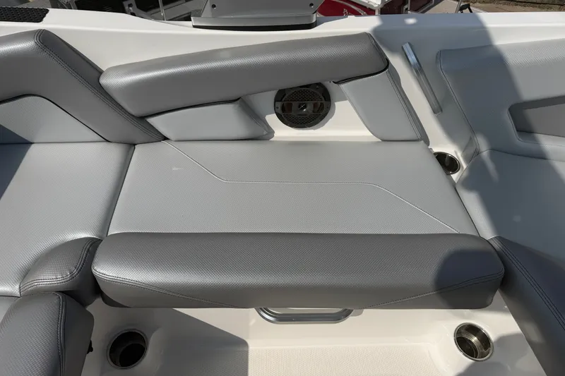 Slide: The Image of 2019 MasterCraft NXT20 boat interior with gray seating and speaker detail. - 14