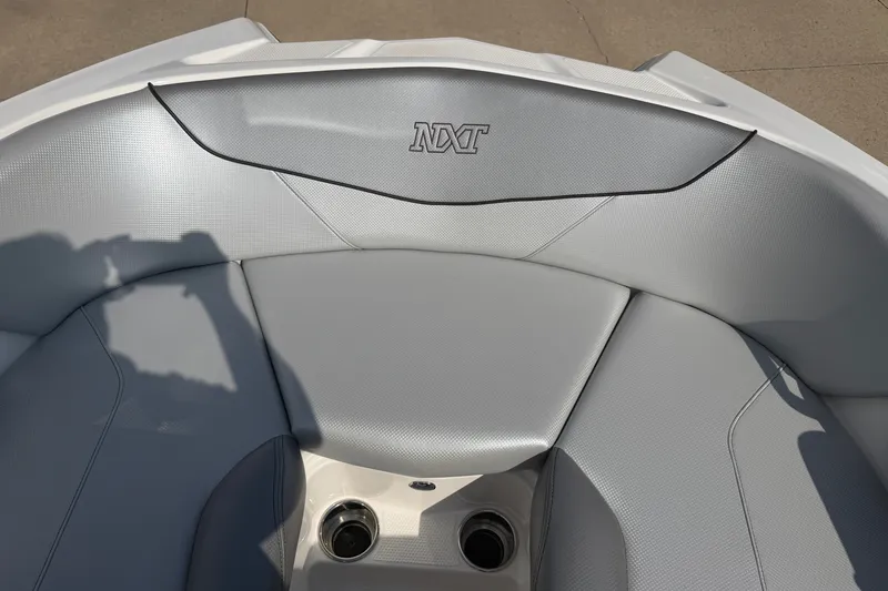 Slide: The Image of 2019 MasterCraft NXT20 boat interior with gray seating and cup holders. - 19