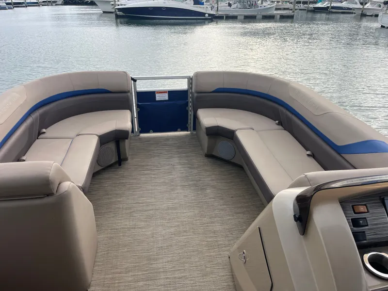 Slide: The Image of The image shows the spacious deck of a 2022 Bennington 23SXSRC with beige seating. - 7