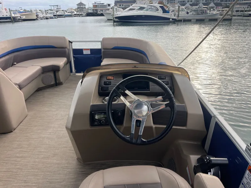 Slide: The Image of The image shows the cockpit of a 2022 Bennington 23SXSRC with a sleek steering wheel. - 4