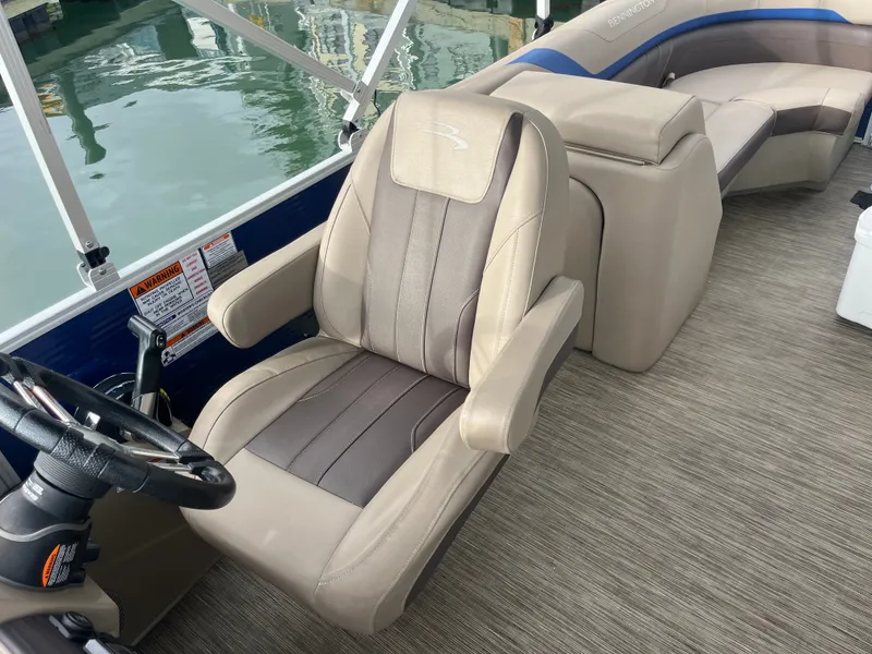 Slide: The Image of The image shows the interior of a 2022 Bennington 23SXSRC with beige leather seating. - 6