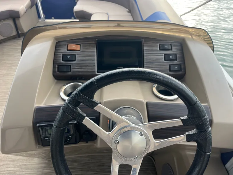 Slide: The Image of The image shows the helm of a 2022 Bennington 23SXSRC with modern controls. - 5