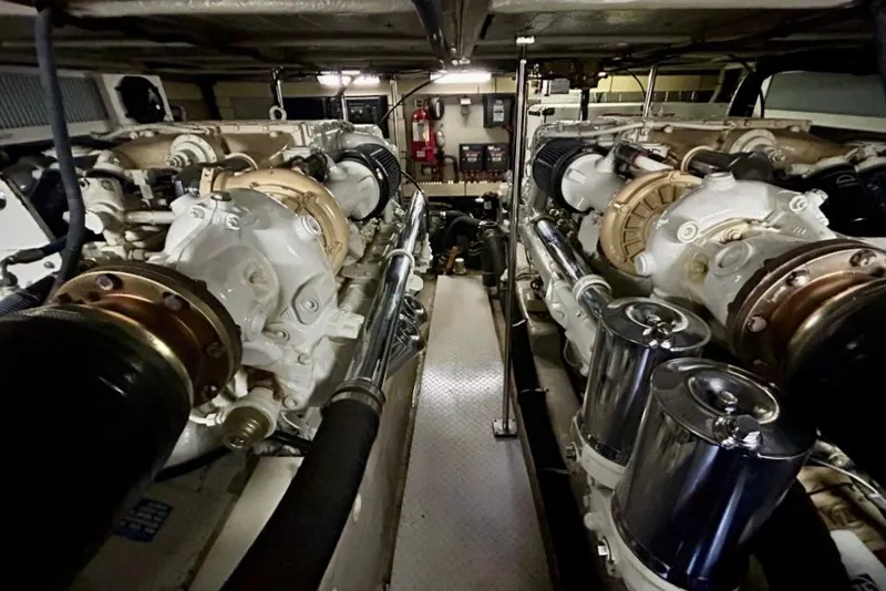 Slide: The Image of Engine room of 2001 Sea Ray 560 Sedan Bridge yacht, showcasing dual engines and mechanical components. - 28