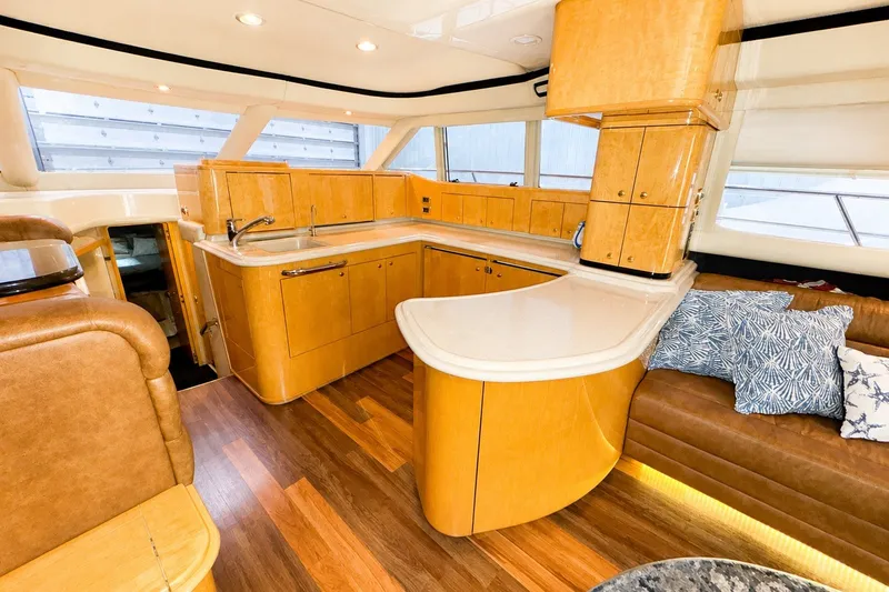 Slide: The Image of Luxurious 2001 Sea Ray 560 Sedan Bridge yacht interior with modern kitchen and seating area. - 18